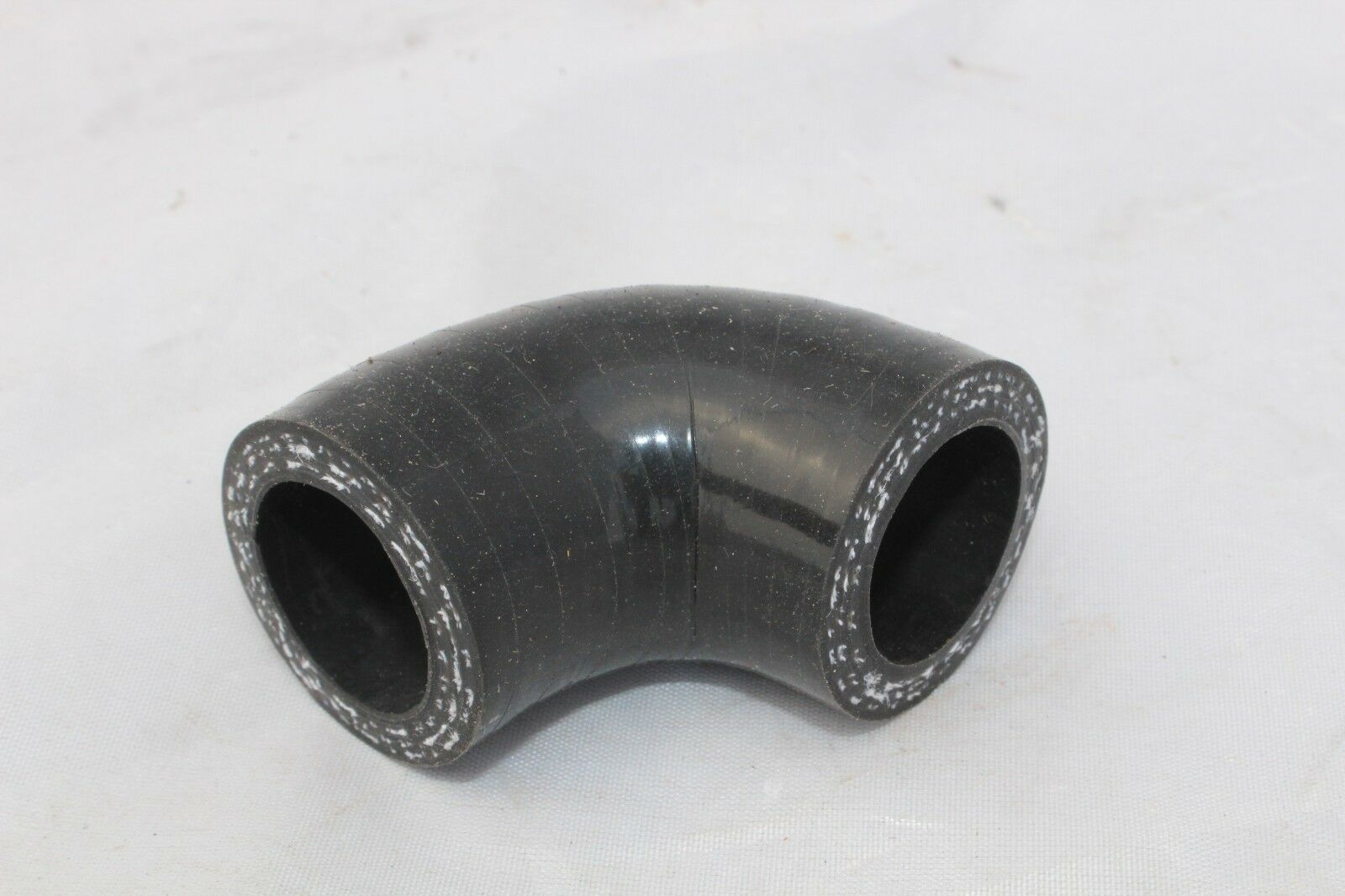 A black hose is bent to the side.