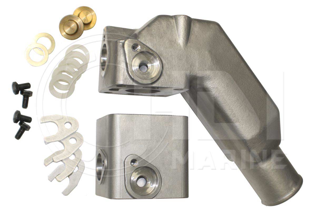 A pair of metal parts with some white plastic and brass hardware.