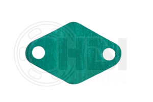 A green rubber gasket that is sitting on the ground.